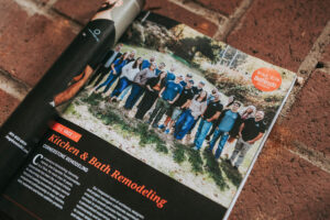Magazine spread with a large group photo outdoors; an orange sticker reads 'FACES Bethesda 2026' on the page