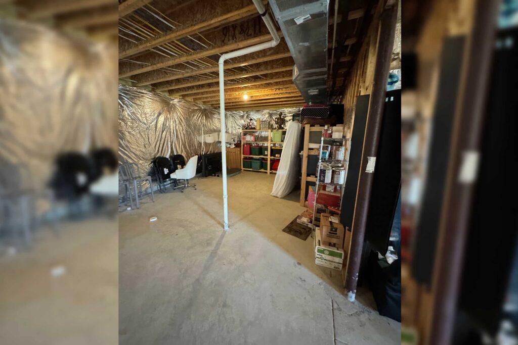 Basement storage area with exposed joists, ductwork, and shelves filled with boxes and bins.