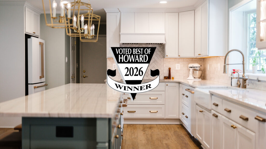 Bright, modern white kitchen with marble island and an overlay badge reading 'Voted Best of Howard 2026 Winner' centered on the image.